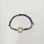 Pulsera macrame negra con sol oro