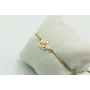Pulsera de macrame en color oro palido y barco dor