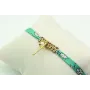 Pulsera lazo liberty azul con flores blancas, macr