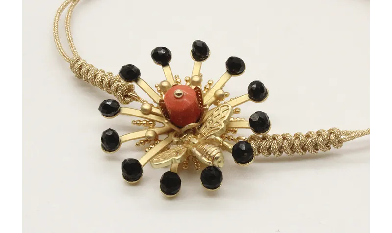 Pulsera nudo serpiente oro palido con sol,casquill