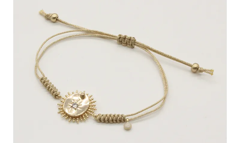 Pulsera nudo serpiente en oro palido con sol y dis