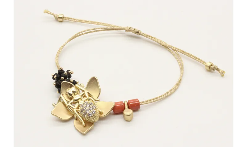Pulsera hilo macrame oro palido con flor oro mate,