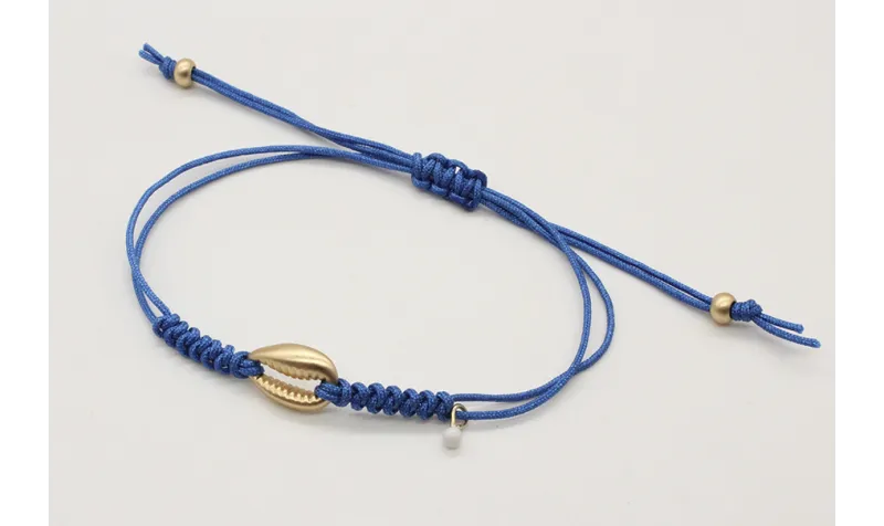 Pulsera nudo serpiente azul con conchita central e