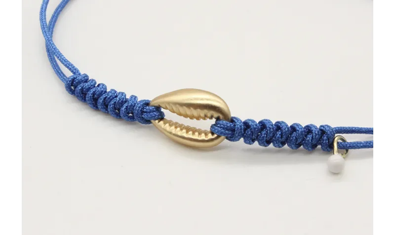 Pulsera nudo serpiente azul con conchita central e