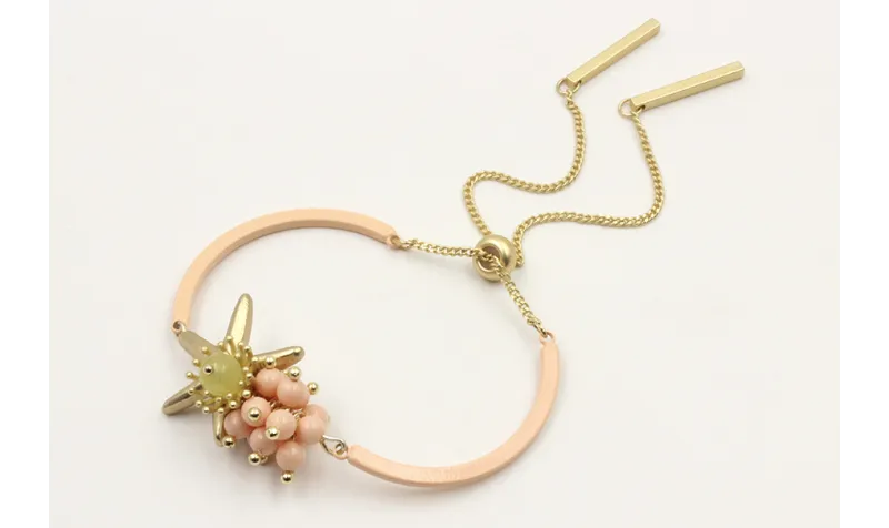 Pulsera semirigida con bolas rositas, estrella oro