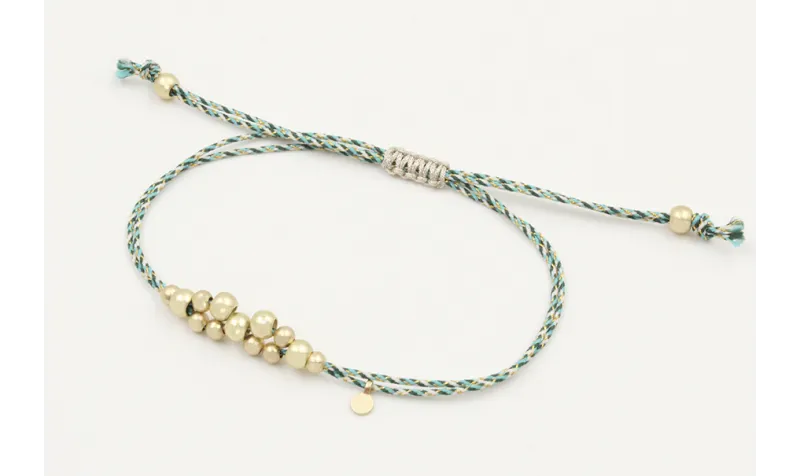Pulsera macrame azul,gris y oro con nudo macrame p