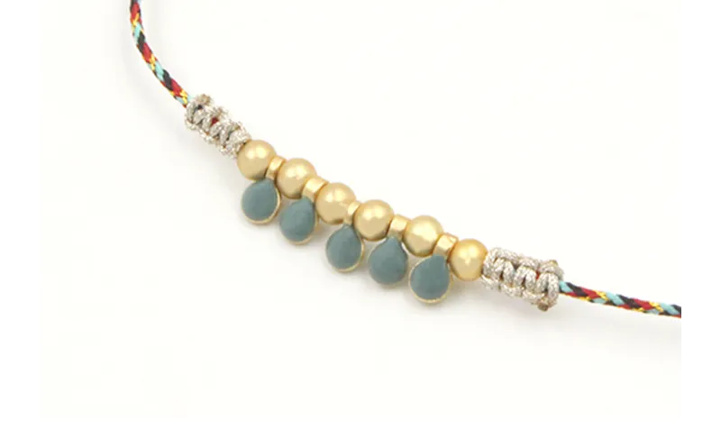Pulsera hilo macrame azul,rojo y oro con nudo macr