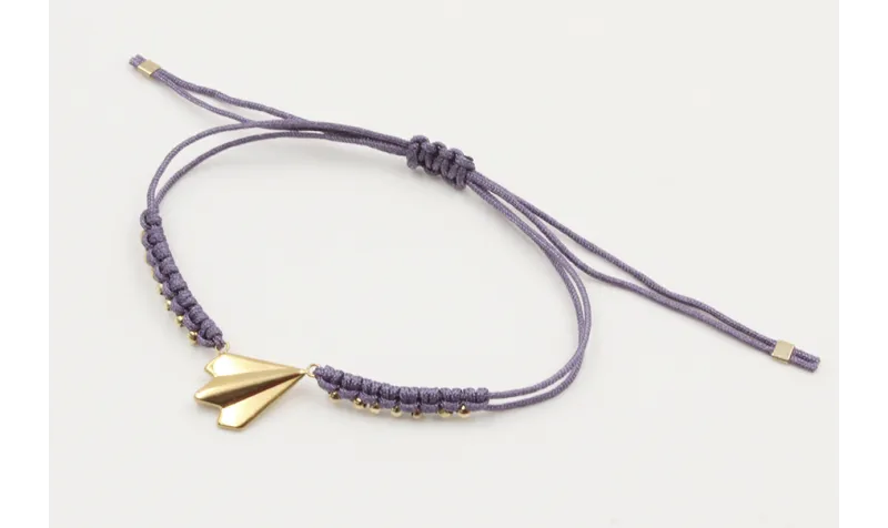 Pulsera macrame morado con bolitas doradas y avión