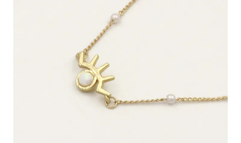 Solitario de cadena con perlas y colgante ojo pest