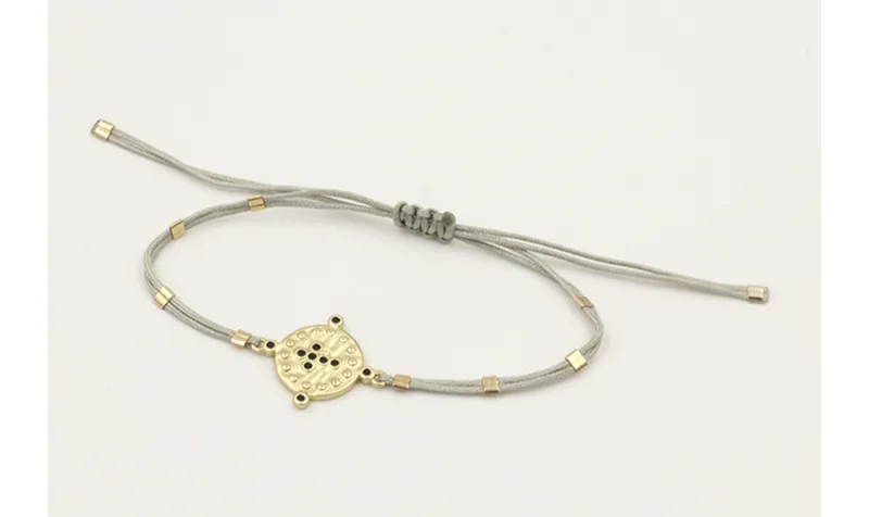Pulsera hilo gris claro con tubitos aplastados y e
