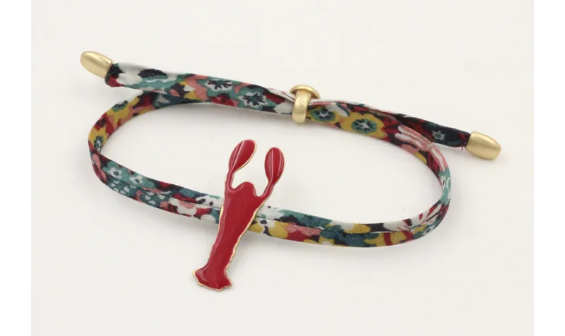 Pulsera lazo liberty azulon con flores rojas,mosta
