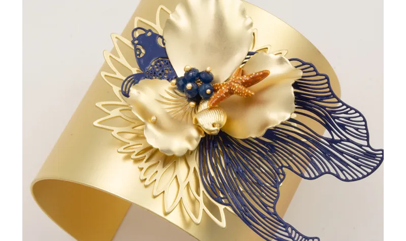 Brazalete rigido flor de loto,pez tropical azul os